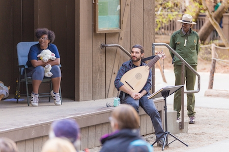 Soheil Fatehi (center) accompanies the troupe on the lute.